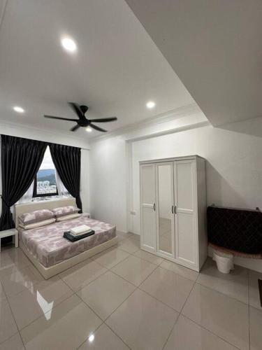 a bedroom with a bed and a ceiling fan at Minimalist City View Home with 3BR at Meru Ipoh in Bandar Meru Raya