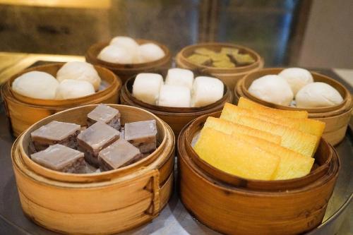 a group of four wooden containers filled with different types of cheese at WYNDHAM Foshan shunde in Shunde