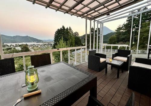 a patio with a table and chairs on a deck at glampark S.O.P Fuji Kawaguchi Lake in Fujikawaguchiko