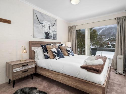 a bedroom with a bed and a window at Inala 7 in Thredbo