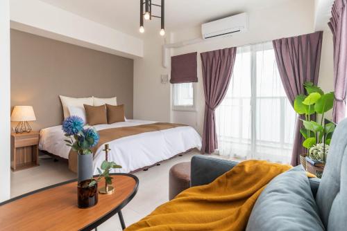 a hotel room with a bed and a table at FDS NEXUS in Osaka