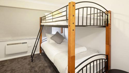 a couple of bunk beds in a room at Yurali in Jindabyne
