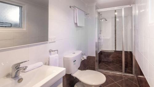 a bathroom with a toilet and a sink and a shower at Yurali in Jindabyne