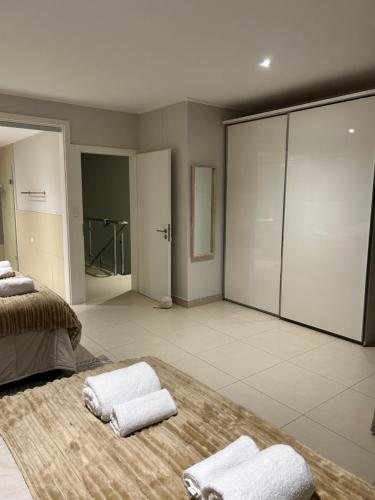 um quarto amplo com 2 camas e toalhas num tapete em The Pier 27 em Swakopmund