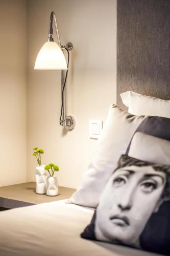 a bed with a picture of a mans face on it at Cidnay Santo Tirso - Charming Hotel & Executive Center in Santo Tirso