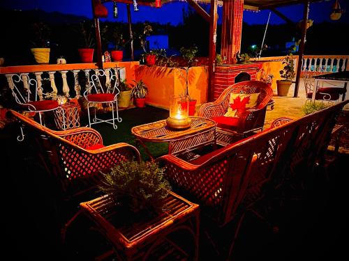 a group of chairs and a table on a porch at Viva Villa in Jhājra