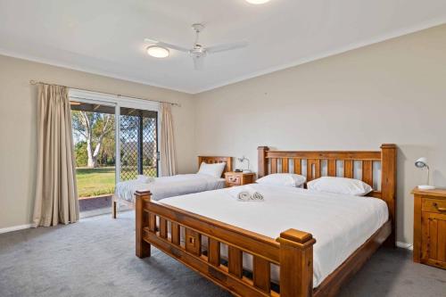 a bedroom with two beds and a window at Mountain Lowry Lodge in Jindabyne
