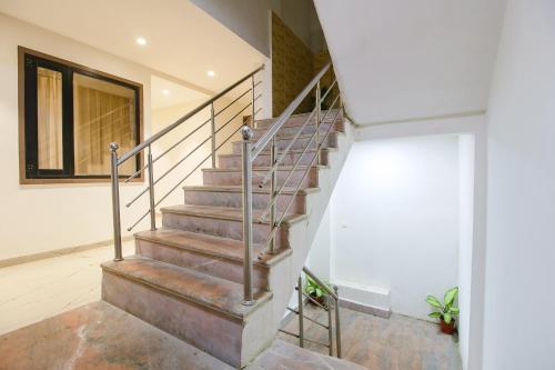 a metal staircase in a house with a window at FabHotel Sharma & Vishnu Garden in Bhopal