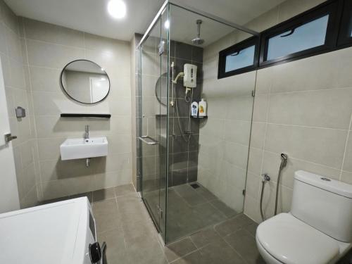 a bathroom with a shower and a toilet and a sink at Solstice Cyberjaya by Idealhub in Cyberjaya