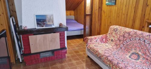 a living room with a couch and a bed at Casa Sofia in Pamparato
