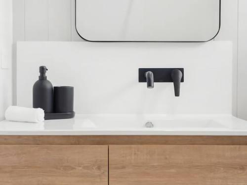 a bathroom counter with a sink and a mirror at Billy Button Retreat in Kalkite