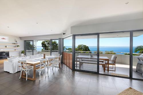 a dining room with a view of the ocean at Sundance in Nelson Bay
