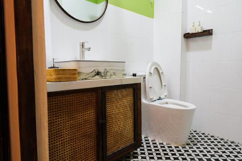 a bathroom with a sink and a toilet and a mirror at Mao Home in Ho Chi Minh City