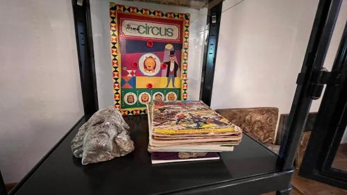 a glass table with a stack of books on it at Domus Merian XII in Trier