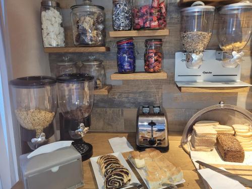 a counter with food and other items on a table at Pro B&B in Osielsko