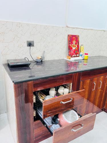 a kitchen with a counter top with a sink at Nirmal sadan Homestay in Barsāna