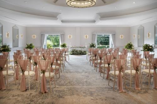 a room with a row of chairs and a room with a row of tables at Delta Hotels by Marriott St Pierre Country Club in Chepstow
