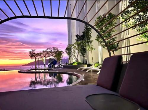 a room with a view of the ocean from a building at The Shore by Casa Yolo 悠乐居 at Kota Kinabalu City Centre in Kota Kinabalu