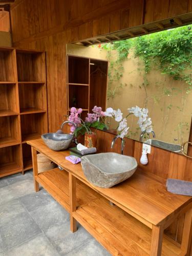 a bathroom with two sinks on a wooden counter at Lobster Bay Lombok in Awang