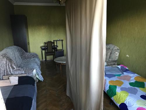 a room with two beds and a curtain in it at T7B hostel in Tbilisi City
