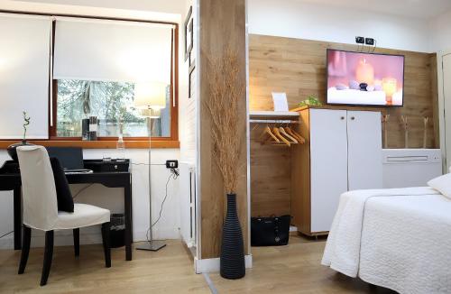 a bedroom with a desk and a bed and a computer at Villa Alba Boutique Hotel in Pescara