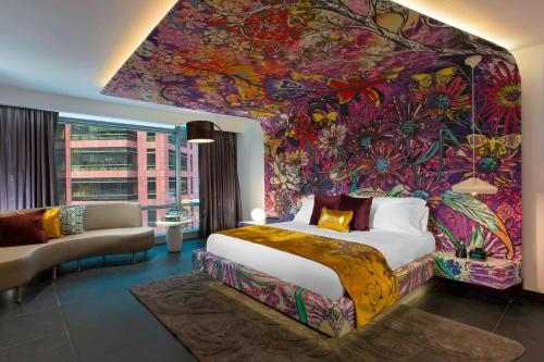 a bedroom with a large flower mural on the wall at W Bogota in Bogotá