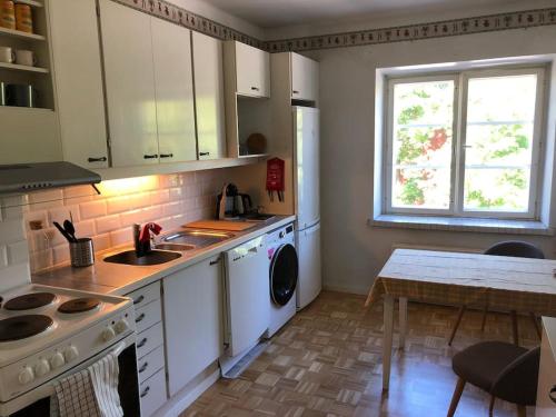 a kitchen with a sink and a stove top oven at Toukola Helsinki 60 m2 apartment. Mi Casa tu Casa in Helsinki