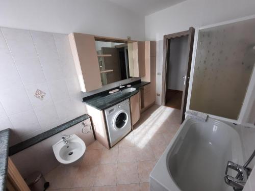a bathroom with a toilet and a sink and a tub at Casa Lore in Tirano