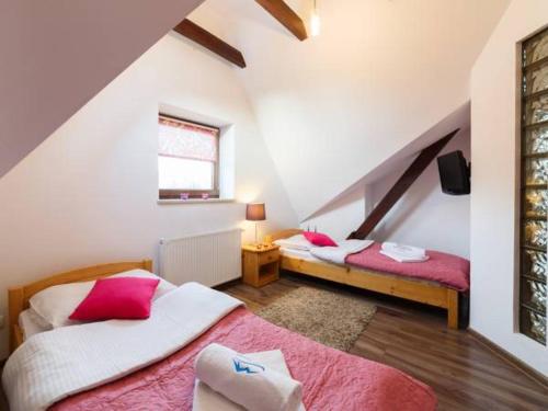 a bedroom with two beds in a attic at Apartament Pod Giewontem in Zakopane
