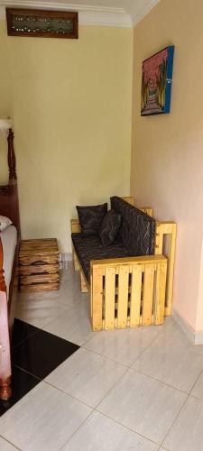 a living room with a couch in a room at Ronnie restate in Jinja