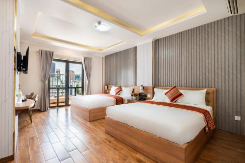 Habitación de hotel con 2 camas y balcón en Luna Saigon Hotel - Bui Vien Walking Street, en Ho Chi Minh