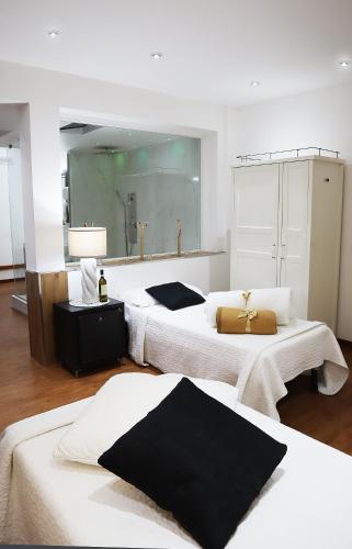 a bedroom with two beds and a large mirror at Villa Alba Boutique Hotel in Pescara