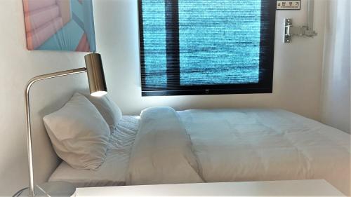 a bed in a room with a large window at Five hotel Jongno in Seoul