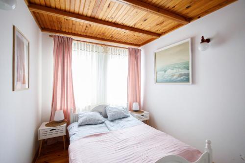 a bedroom with a bed and a large window at Apartament Miriada 16 in Rowy