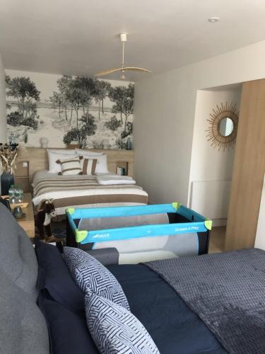 a bedroom with two beds with blue and white at Les clés d'à côté - maison d'hôtes de charme près de Rouen in Sotteville-lès-Rouen