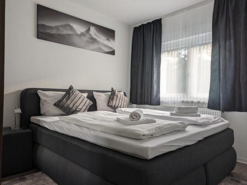 a bedroom with a large bed in a room at Hotel Ari in Kaiserslautern