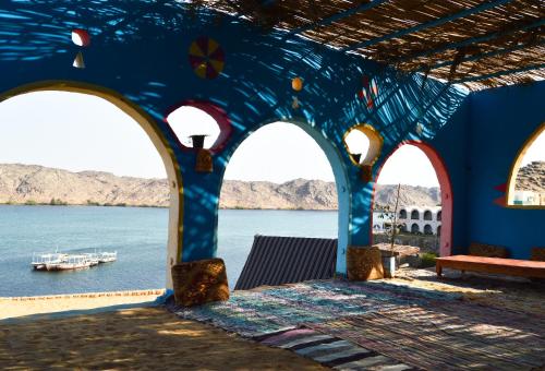 un edificio blu con vista sull'acqua di Heissa Hostel a Aswan