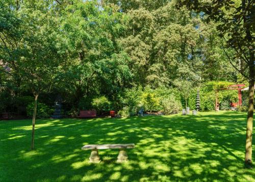 a park with a bench in the middle of a field at The Iflissen Nest - Luxury Appartment in Lamorlaye