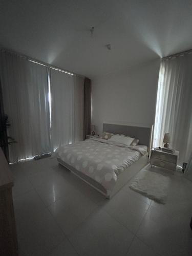 a bedroom with a bed and a large window at Love place in Abu Dhabi