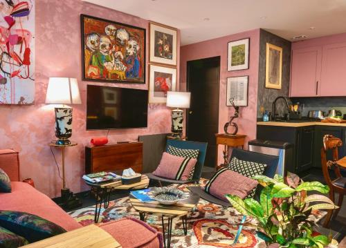 a living room with a couch and a tv at The Iflissen Nest - Luxury Appartment in Lamorlaye
