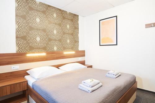 Postel nebo postele na pokoji v ubytování Wellness Hotel Kocanda