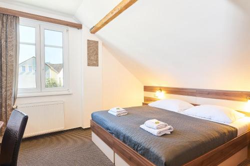 Postel nebo postele na pokoji v ubytování Wellness Hotel Kocanda