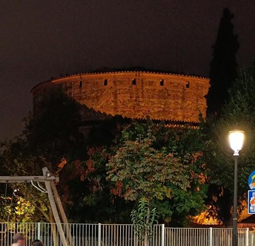 a large brick building at night with a street light at M&M's house in Thessaloniki