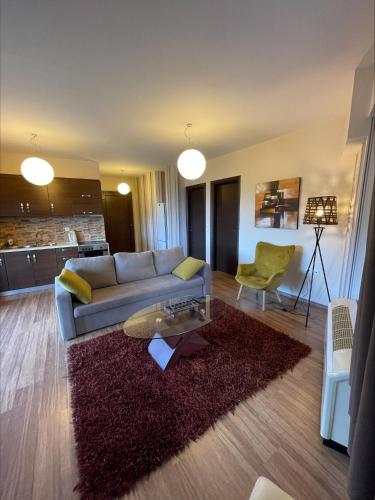 a living room with a couch and a rug at 7Hills by Life Houses in Eptalofos