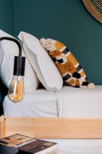 a white couch with pillows and a vase on it at Sea´ya Thoughtful Stays - Villa Areia in Cascais