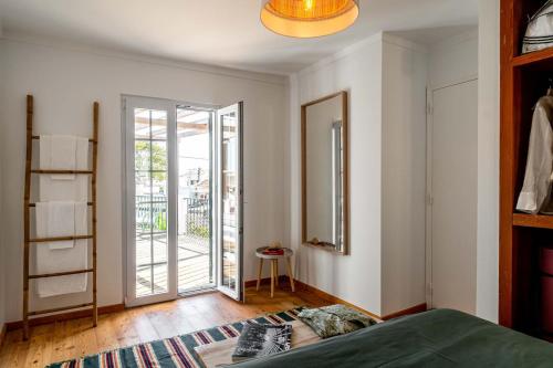 a bedroom with a bed and a sliding glass door at Sea´ya Thoughtful Stays - Villa Areia in Cascais