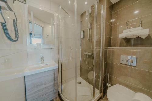 W łazience znajduje się prysznic, toaleta i umywalka. w obiekcie KYRIAD DIRECT ORLEANS NORD - Cap Saran w mieście Saran