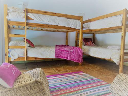 a living room with two bunk beds and a chair at Fashion Villa in Vilamoura with Private Pool in Quarteira