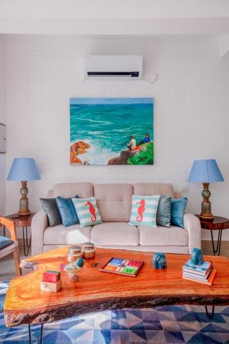 a living room with a couch and a table at El Rocio Estate 2bhk in Assagao with Common pool, Free Parking,8 min away from Vagator in Assagao