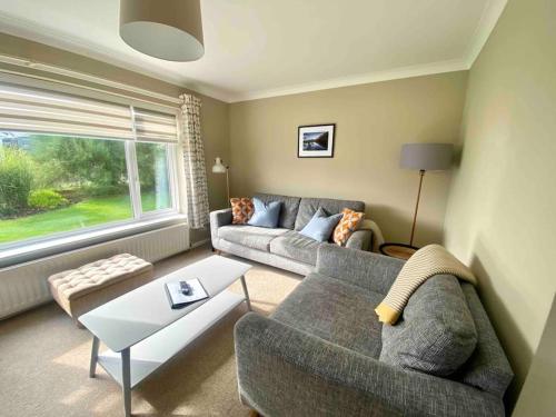 a living room with a couch and a table at Number 3 in Penrhyn Bay